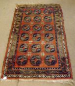 A Caucasian Rug, central panel of geometric lozenges, mainly rust/orange field with green detail,