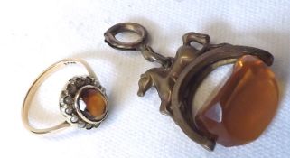 A gilt metal Fob set with an Amber type stone; together with a further small Citrine and Seed