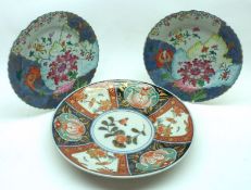 A near pair of 18th Century Chinese Plates, painted with geometric floral designs in shades of