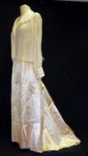 A Victorian Bustle Skirt in glazed peach satin, half-lined in lawn cotton edged with needlepoint