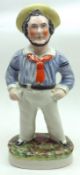 A 19th Century Staffordshire Figure of a rotund sailor, decorated in colours on an oval plinth base,