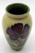 A small Moorcroft Wide-Necked Vase, Dianthus pattern, decorated with floral sprays on a green and
