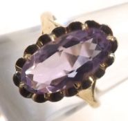 A yellow metal Ring marked 9ct set with a single oval purple stone