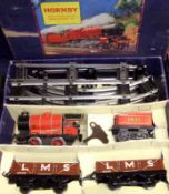 A Hornby O Gauge Tinplate Clockwork Train Set, to include Red Locomotive and Tender; two LMS Plank