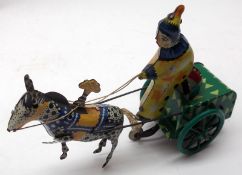 A Tinplate Clockwork Horse and Trap Figure, driven by a clown (in cabinet on back wall)