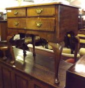 An 18th Century and later Walnut Lowboy, with two short and one full length drawer, raised on