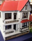 An early 20th Century Colonial style scratch built Dolls House, double opening front to reveal