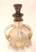 An early 20th Century Liqueur Decanter of spherical form with three looped solid glass handles,