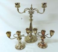 A large Silver Plated Two Branch Candelabra, with knopped stem on a round foot; together with a pair