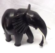 A 20th Century Ebony Model of an Elephant with bone or ivory tusks, 11” high