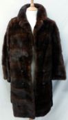 A mid-20th Century Ladies ¾ length mid-brown Mink Coat, double breasted style with decorative button