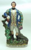 A 19th Century Staffordshire Figure of Robert Burns decorated throughout in colours and raised on