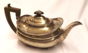 A George III Squat Teapot of typical form, the hinged lid with a wooden finial to a swept body