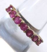 A hallmarked 9ct Gold Ring set with seven small Rubies