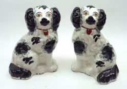 A pair of 19th Century Staffordshire Model Spaniels, of typical form and decorated in black and