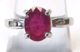 A hallmarked 9ct Gold centre oval Ruby Ring with a small Diamond to each shoulder, the ruby