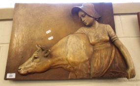 A 20th Century Austrian China Wall Plaque, modelled as a milkmaid and cow, decorated on a brown