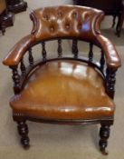 A 19th Century Bow Back Library Chair the bowed back with brown buttoned leather upholstery, spindle