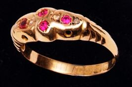 An 18ct Gold hallmarked Ring set with red stones and small Diamonds