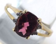 A hallmarked 9ct Gold Ring set with Rubellite and four small Diamonds