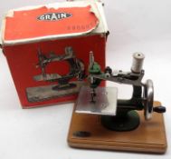 E L Grain (Sewing Machines) Cast Metal Child’s Sewing Machine, mounted on pine base