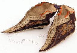 A pair of late 19th Century Chinese Lotus Shoes for bound feet, black silk embroidered with dragon