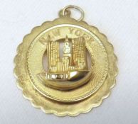 A yellow metal “New York” Commemorative Pendant marked 14K