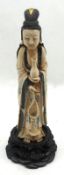 An early 20th Century Japanese Carved Ivory Figure of a girl clutching a vase and a string of beads,