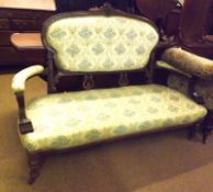 A Victorian Walnut Sofa, oval back crested with a floral moulded pediment and raised on short lyre