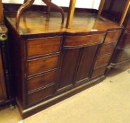 An early 19th Century Mahogany Sideboard, the top with raised edge and bowed central frieze drawer
