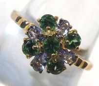 A hallmarked 9ct Gold Ring set with four Tanzanites and five Tsavorites