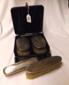 A cased pair of Gents engine-turned Silver Backed Hairbrushes, together with the matching Comb,