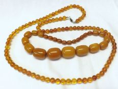 A Polished Amber Bead Graduated Necklace (approx 45 gm total); together with a further Amber type
