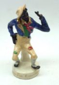 A 19th Century Staffordshire Model of Jim Crow in seated position, raised on round plinth base, (