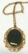 A yellow metal oval Pendant set with a green stone, marked 9ct, on an unmarked gilt metal chain