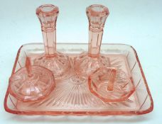 An early 20th Century Glass Dressing Table Set, comprising Tray, Ring Stand, pair of Candlesticks