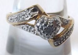 A yellow metal Ring marked 10K, centre setting with Diamond chips forming a heart