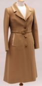 A 1976 Norman Hartnell Classic styled Ladies Coat, in a soft caramel brown wool fabric with cream