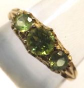 A hallmarked 9ct Gold Ring set with three green stones