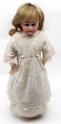 A German Bisque Head and Shoulder Plate Character Doll, with fixed brown glass eyes, painted lashes,