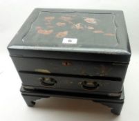 An early 20th Century Oriental Lacquered Table Casket of rectangular form, the lifting lid enclosing