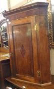 A 19th Century Wall Mounted Oak and Mahogany Corner Cabinet of typical form, moulded cornice to a