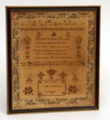 A Needlework Sampler, decorated with a floral border, several lines of letters and religious text,