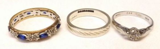 A Mixed Lot comprising: a 9ct White Gold Wedding Ring with facetted decoration; a mid-grade precious