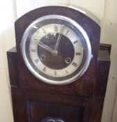 A small early 20th Century Oak Cased Grandmother Clock, circular face with silvered chapter ring and