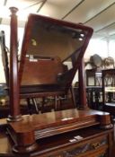 A substantial Victorian Mahogany Swing Dressing Table Mirror, the mirror supported on octagonal