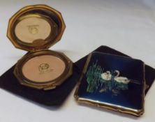 Two Stratton’s Gilt Metal Compacts, one with lithographic detail of swans (2)
