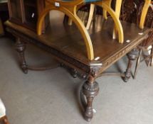 A Victorian Gothic Oak Extending Dining Table, the corners with carved lion mask detail, raised on