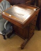 A Victorian Walnut Davenport Desk of typical form, with sloped front, lifting lid, fitted interior