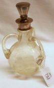 An early 20th Century Liqueur Decanter of spherical form with three looped solid glass handles,